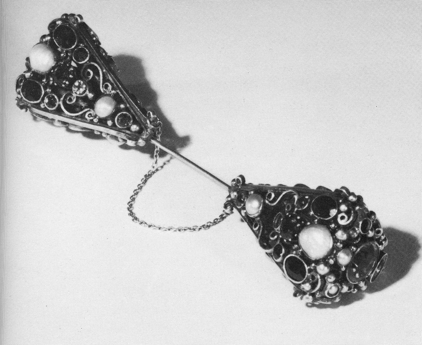A silver sureté pin set with coloured stones and baroque pearls, by Dorrie Nossiter, Hinks 1983 plate 96. Image